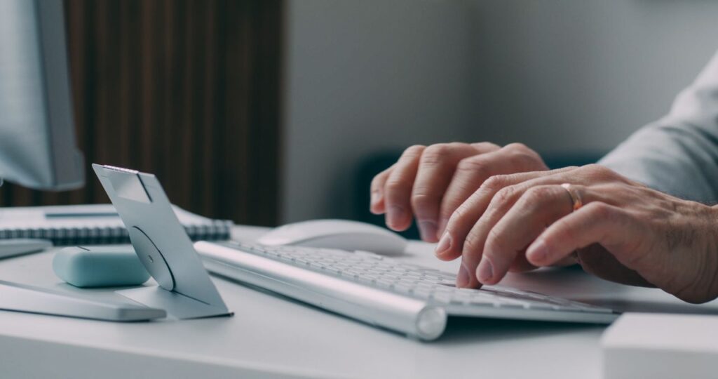 pexels-photo-30535780-30535780 Hands typing on a keyboard at a modern workspace, close-up view.